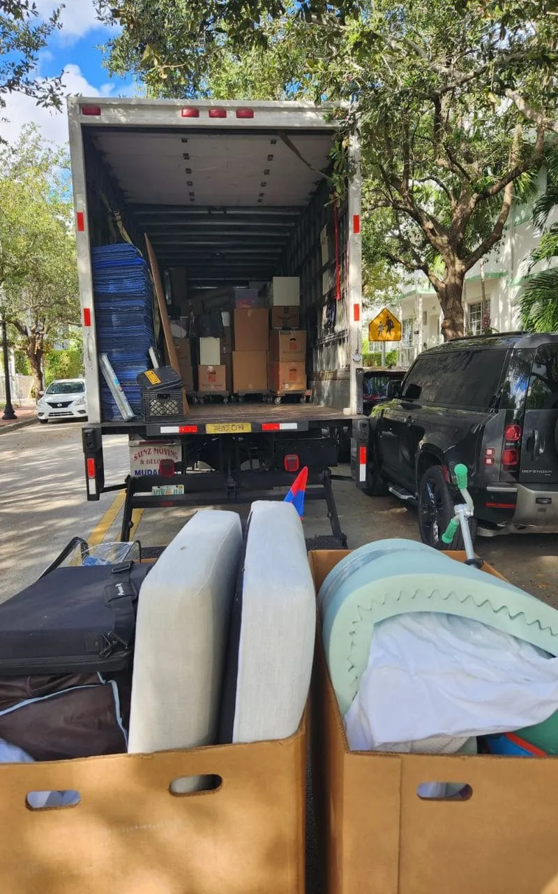 Packed Sainz Moving truck with boxes and cushions ready to unload