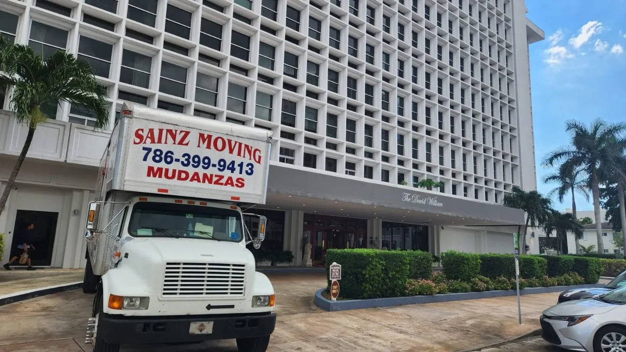 Front of the Sainz Moving & Delivery truck outside a Miami high-rise