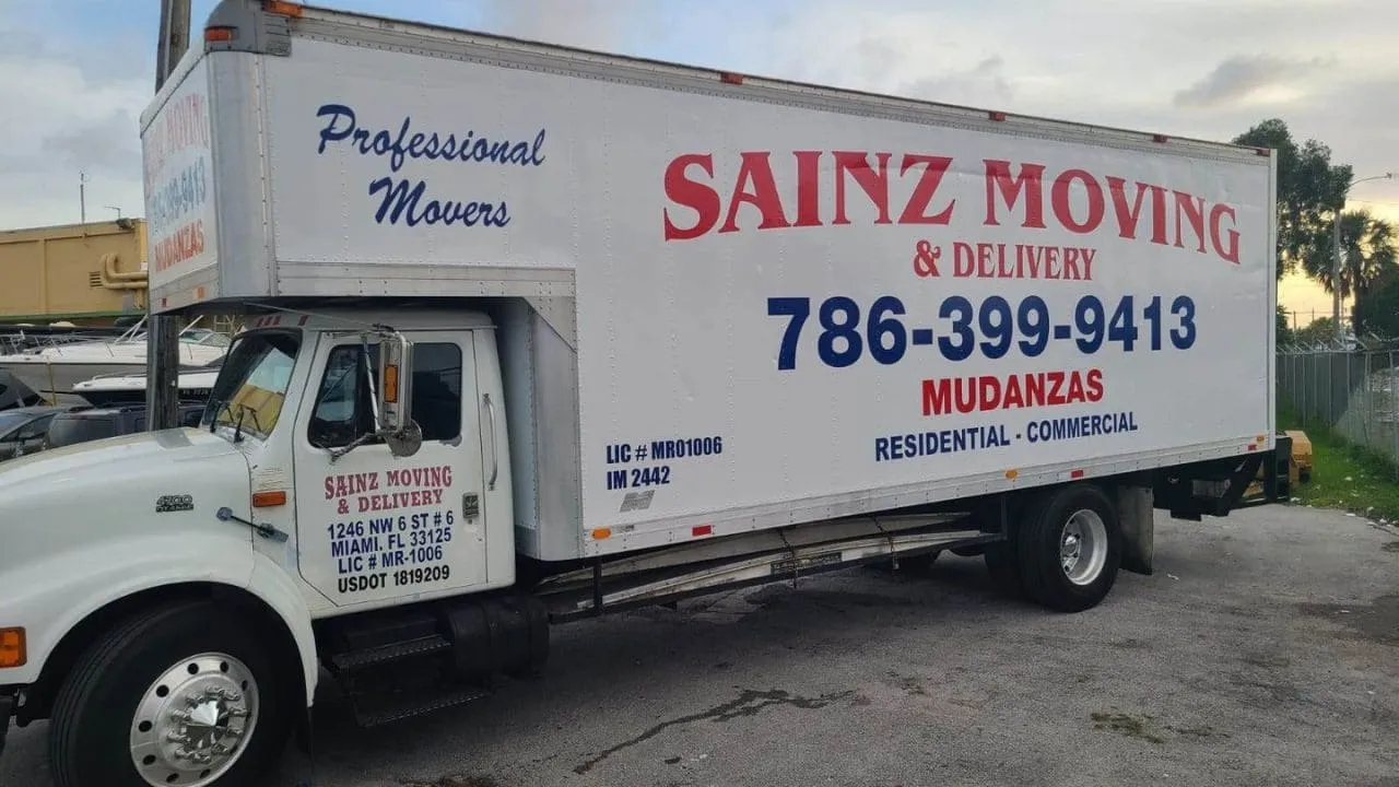 Side of the Sainz Moving & Delivery box truck with phone number and Mudanzas