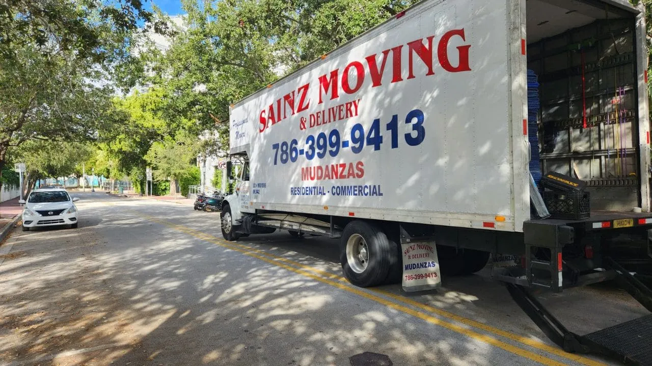 Sainz Moving truck with lift gate lowered on a Miami street